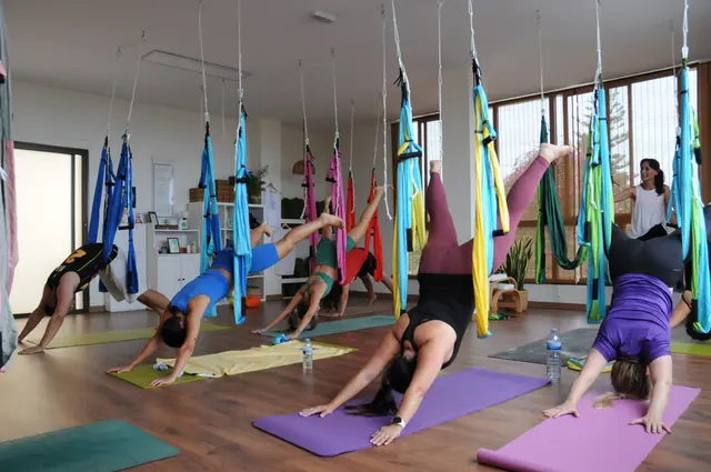 Cira teaching an aerial yoga class at Tushala