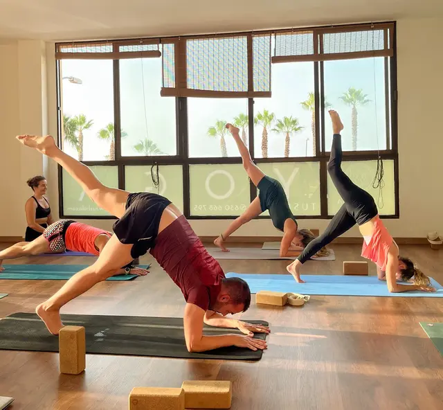 Students preparing for pincha pose.